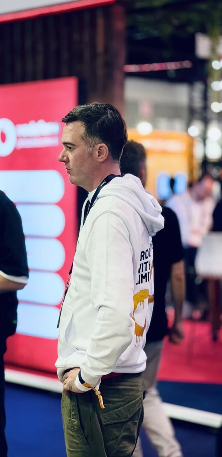 Harry from the Pactum team mid-conversation with a visitor at the stand