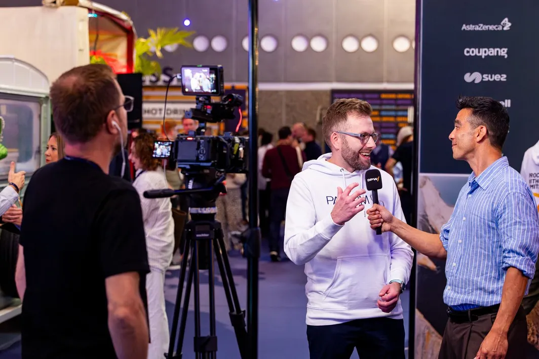 Daniel Barnes, the author of this piece, being interviewed on camera at the Pactum stand