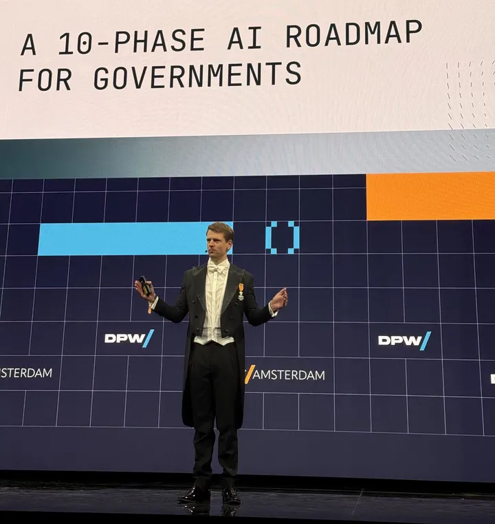 Kaspar Korjus in front of a slide reading A 10-phase AI roadmap for governments