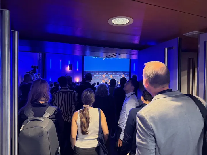 People standing at the back of the room to watch the session