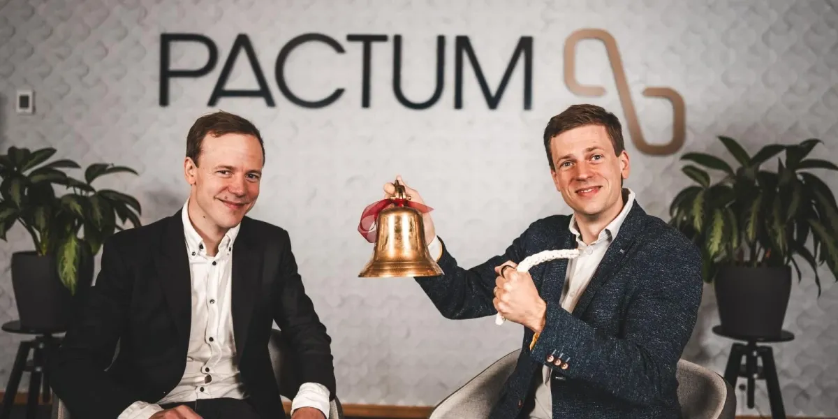 Pactum co-founders with a bell at the Pactum office.