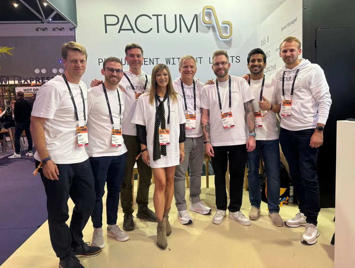 The Pactum team in front of the stand